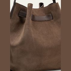 Brunello Cucinelli bucket bag in soft velour leather  Adjustable shoulder strap Open top with adjustable buckle strap  Approx. 12.2"H x 10.2"W x 6.7"D Made in Italy Open Top, Brunello Cucinelli, Bucket Bag, Shoulder Strap, Tops Designs, In Italy, Buckle, Italy, Luxury Fashion