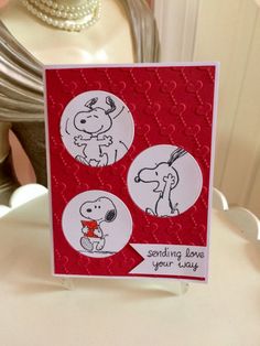 a handmade card with two pictures of a dog and a person holding a heart