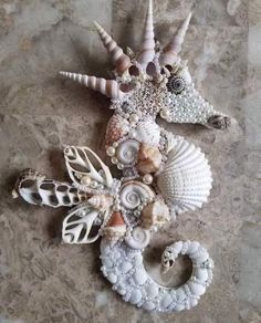 sea shells and seashells are arranged on a marble surface, including one starfish