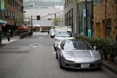 a silver sports car parked on the side of a street