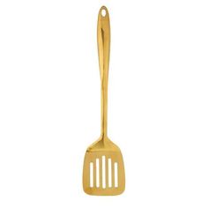 a gold colored spatula on a white background