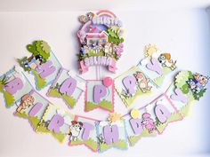 a happy birthday banner hanging on the wall with animals and trees around it, surrounded by cut out letters