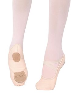 a woman's feet in ballet shoes with white socks