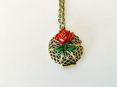 Inspired by Belles enchanted rose from Beauty and the Beast is a small brass filigree locket. The locket is 25mm and features a rose that I hand painted red with a green stem. It opens to the quote, 'until the last petal falls' The locket hangs on a lead and nickel free brass chain. You may select your preferred chain length at check out. Your locket will arrive to you beautifully packaged and ready for gifting. Victorian Metal Locket Necklace For Gift, Victorian Metal Locket Necklace Gift, Victorian Style Metal Locket Necklace Gift, Vintage Charm Locket Necklace With Flower Pendant For Gift, Vintage Rose Gold Jewelry With Flower Charm, Nickel-free Bronze Locket Necklace Gift, Nickel-free Bronze Locket Necklace As Gift, Bronze Nickel-free Locket Necklace For Gift, Bronze Necklaces For Valentine's Day Gift