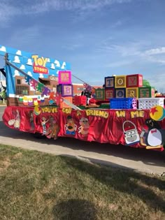 there is a very large toy truck with many items on it's back and sides