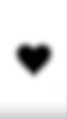 a black and white photo of a heart shaped object in the air, with only one eye visible