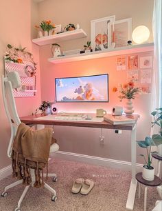 a desk with a computer on top of it and some plants in front of it