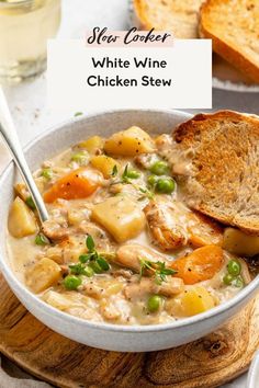 a bowl of white wine chicken stew with bread on the side