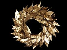 a gold wreath is shown against a black background