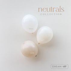 three white balloons with the words neutrals collection written on them are in front of a white background