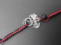 Dragon charm bracelet/ Essential oil bracelet/ fantasy bracelet/ Dragon Diffuser bracelet/ Aroma theraphy bracelet/ Macrame bracelet/ Animal charm bracelet/ Dragon lava bracelet/ Dragon adjustable bracelet/ friendship bracelet/ red and black dragon bracelet. This listing is for one (1) bracelet only This bracelet is nicely placed in a gift bags size (9x7cm).. This fantasy bracelet was made Chinese wax cord 1mm, with a Natural black lava stone 8mm beads, the dragon measures 34.5mm long 27.5mm wid Red And Black Dragon, Fantasy Bracelet, Oil Bracelet, Essential Oil Bracelet, Bracelet Macrame, Dragon Bracelet, Lava Bracelet, 8mm Beads, Bracelet Friendship