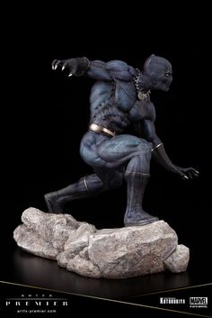 the black panther statue is posed on a rock