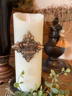 a white candle sitting on top of a wooden table