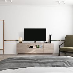 a bedroom with a large flat screen tv on top of a wooden entertainment center next to a bed