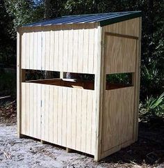 a wooden outhouse sitting in the middle of a forest