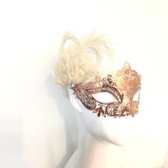 This filigree laser cut mask painted, embellished with Rhinestones and adorned with ivory feathers. S H I P P I N G - Processed same day or within 24 hours. 1-2 day guaranteed delivery, add item to cart, click shipping tab for rates. Pls leave a check out note with your need date & contact number Msg for delivery time frames (Include your state/country) S I Z E Measures approx. 9 inches in length, 4 inches in Width from forehead to nose. Detailed dimensions available upon request. C U S T O Elegant Feathered Masquerade Mask, Elegant Wedding Masks, Elegant Feathered Eye Mask For Masquerade, Elegant Feathered Masquerade Mask For Mardi Gras, Elegant Feathered Masquerade Mask For Costume Party, Masquerade Carnival Headpiece, Elegant Headpieces For Masquerade Carnival, Elegant Headpieces For Carnival Masquerade, Elegant Mardi Gras Masks And Prosthetics