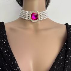 Make a statement with this Layered Pearl Choker Necklace with 5 layers of pearls and stunning pink diamanté brooch. Materials: 6mm Luxurious Shell Pearls, Rhinestones brooch, Gold plated brass clasp. Shell pearls are made from crushed shells. Oyster shells are cut and transformed into powder and then reformed into perfect pearl shape with an infinite shine. They are very popular as a natural alternative to expensive pearls.  Each glossy bead is crafted to mimic the radiant beauty of real pearls, Elegant Pink Pearl Necklace For Party, Elegant Pink Choker Jewelry, Vintage Pearl Choker For Party, Pink Pearl Jewelry For Party, Glamorous Pearl Choker Necklace, Elegant Pink Rhinestone Necklace For Party, Glamorous Pearl Necklace As Gift, Elegant Pink Rhinestone Party Necklace, Glamorous Pearl Necklace For Gift