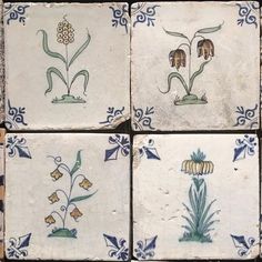 four blue and white tiles with flowers on them