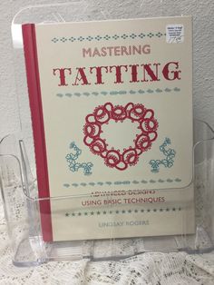 a book about tatting is sitting on a table