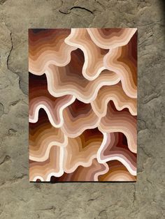 an abstract painting on a stone wall with brown and tan colors in the background,