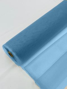 a roll of blue fabric sitting on top of a table