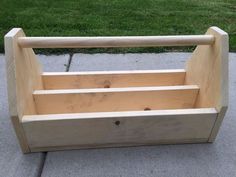 a wooden toy box sitting on the sidewalk