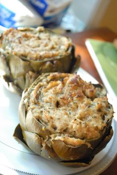 two stuffed mushrooms sitting on top of a white plate