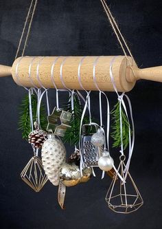 an ornament hanging from a wooden pole with christmas decorations on it's hangers