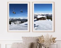 two framed pictures hang on the wall above a couch in front of a chairlift