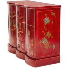 three red painted wooden boxes with flowers and birds on the front, one is closed