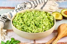 an avocado salad is in a bowl next to some sliced avocados