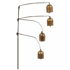 three brass colored lamps hanging from a metal pole