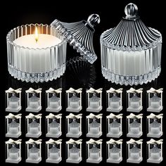 twelve clear glass candle holders with candles in them