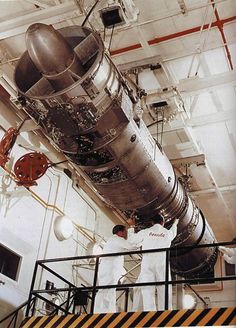 two men working on a large metal object