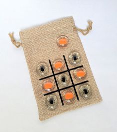 an orange and black tic - board sitting on top of a burlap bag