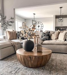 a living room filled with lots of furniture and decor on top of a carpeted floor