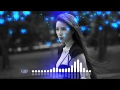 a woman with long hair standing in front of a blue and white background that has sound waves