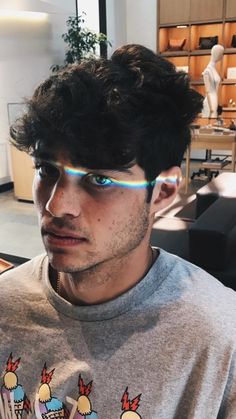 a young man with glasses on his face looking at the camera while wearing an ice cream t - shirt