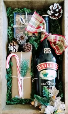 a bottle of bailey's and some christmas decorations in a box