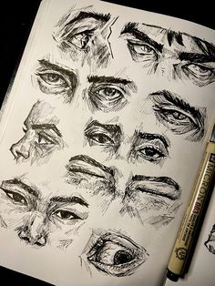 an open notebook with drawings of different eyes