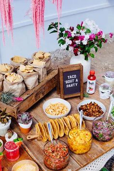 a table filled with tacos and other foods