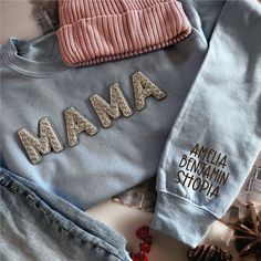 Custom Mama Sweatshirt with Kids and Pets Names on the Sleeve  IMPORTANT NOTE Please make sure to CHECK YOUR Email Or your Etsy Conversations after you placed an order until you receive your package in case we have a question regarding your order! The use of the messaging system is very easy and convenient and you can always expect a timely reply during business days/hours. We are not responsible for packages that do not make it in time of your event if you did not give us a "Date Needed by" at Name Print Tops As Winter Gift, Winter Name Print Top As Gift, Personalized Cotton Sweatshirt For Winter, Customizable Cotton Tops For Winter, Custom Mama Sweatshirts, Personalized Mama Sweatshirt, Mama Pullover, Mother's Day Personalized Crew Neck T-shirt, Mother's Day Custom Print Crew Neck T-shirt