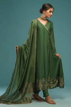 Reema is an elegant raw silk angharka in the hues of green with beautiful mehrab and floral motifs on the borders embellished with sheesha, kora, dabka giving a luxurious look. This angharka is paired with a cotton silk churidar and khaddi net screen printed dupatta finished with lace. These luxury semi formals, ready Luxury Green Shawl For Eid, Luxury Cotton Silk Dupatta With Printed Border, Velvet Suit Design, Silk Churidar, Printed Dupatta, Velvet Suit, Organza Dupatta, Mauve Color, Suit Designs