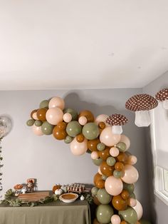 a table topped with lots of balloons next to a wall