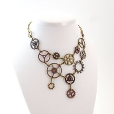 "A mechanical meshwork to decorate the décolleté.  This steampunk bib-style necklace made of gears has a lay-flat design that won't tangle with itself and is comfortable to wear.  The wide links make it look heavier than it actually is.   For a statement piece, it is quite comfortable, and adjustable to be worn tight like a choker if desired.  Finished in assorted metal colors. *Some photos and video are for example only.  You will receive one necklace of the style you select (notice that style Charector Ideas, Eli Outfits, Steampunk Accessories Diy, Steampunk Stuff, Ren Fair, Steam Punk Jewelry, Amazing Clothes, Steampunk Gears, Bib Collar