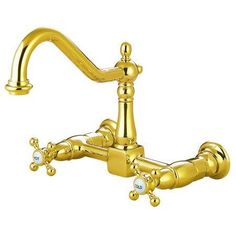 a golden faucet with two handles and nozzles