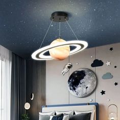 a bed room with a neatly made bed and a ceiling light hanging from the ceiling