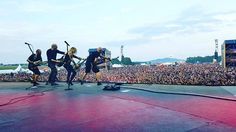 a group of people standing on top of a stage next to each other in front of a crowd