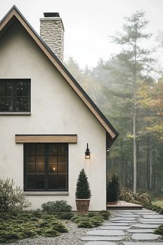 Scandinavian house exterior modern design showcasing natural materials earthy colors and large windows in peaceful forest backdrop White And Wood Exterior House, White Scandinavian House Exterior, Cottage Modern House, Modern European Home Exterior, Scandinavian Exterior House, European Home Exterior, European Farmhouse Exterior, Scandinavian House Exterior, Rustic House Exterior