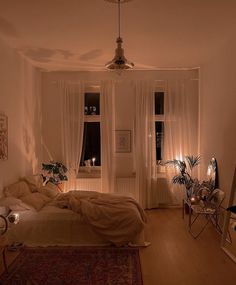 a bed room with a neatly made bed next to two windows and a rug on the floor